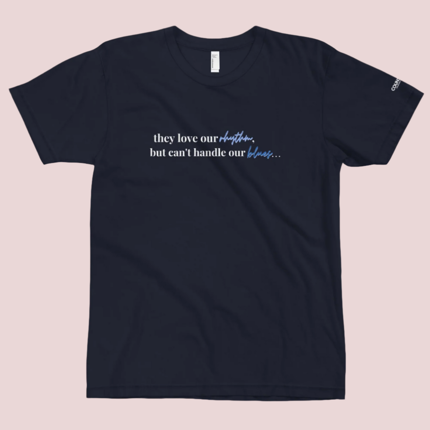 A navy blue t-shirt with the text "They love our rhythm, but they can't handle our blues" on the front.