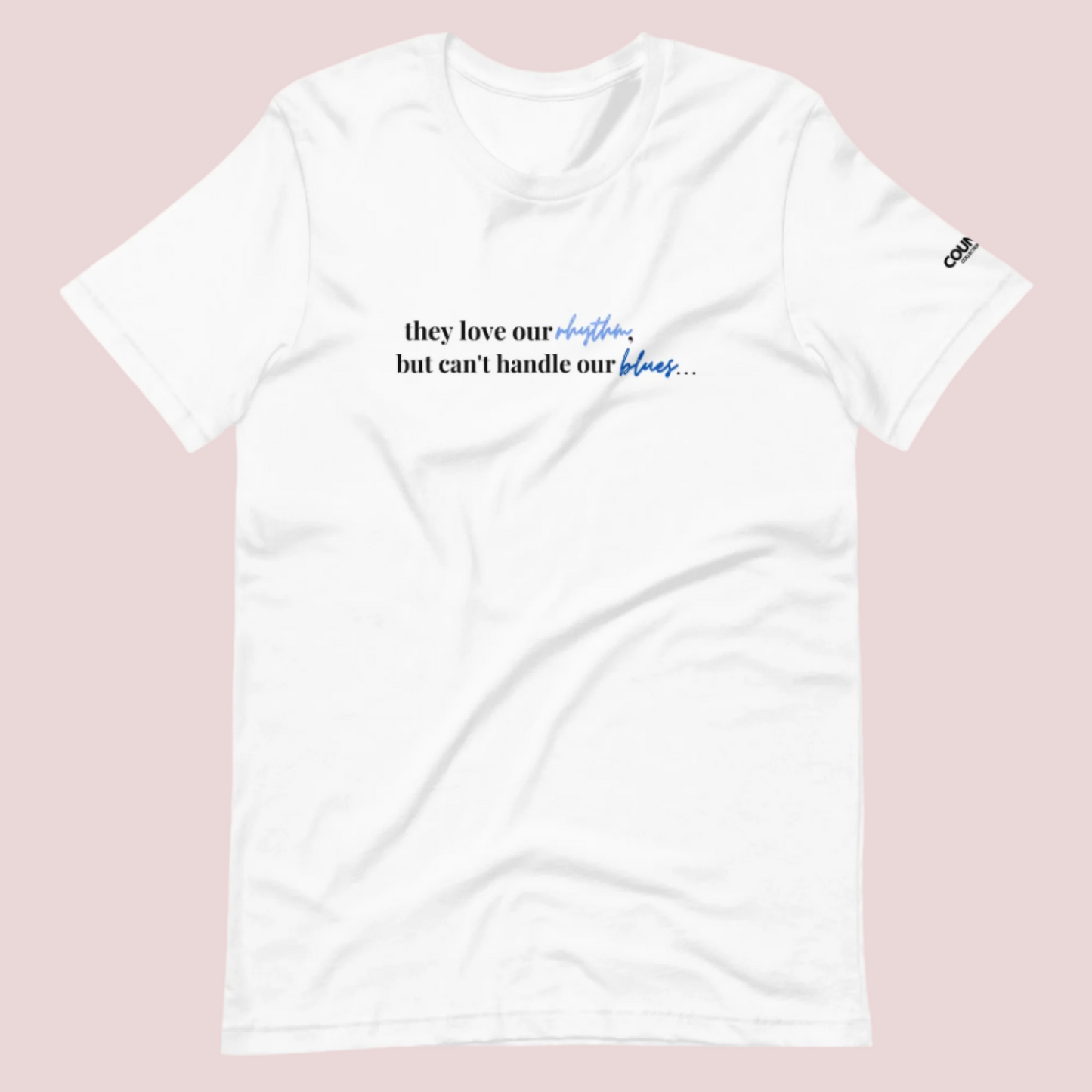 A white t-shirt with the text "They love our rhythm, but they can't handle our blues" on the front.