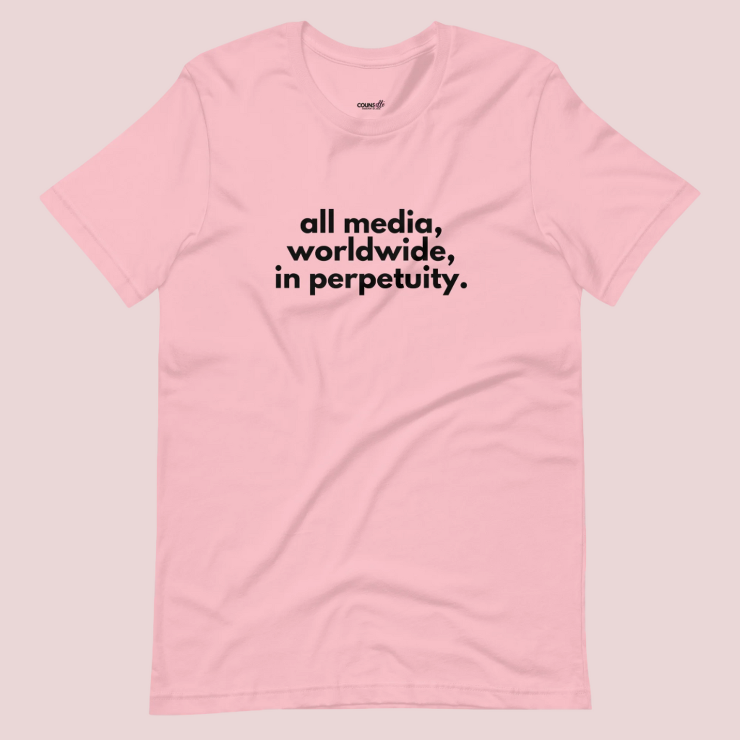 A pink roundneck tee showing the text "all media, worldwide, in perpetuity."