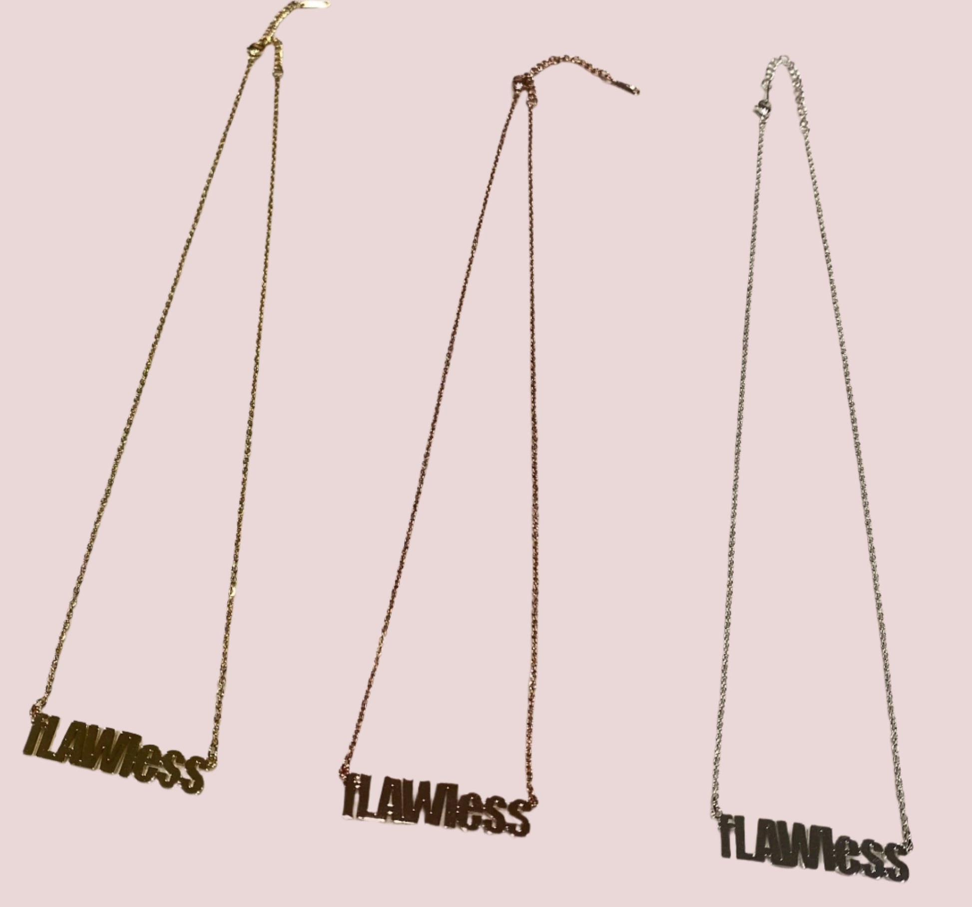 A chain necklace featuring the text "fLAWless" as a pendant