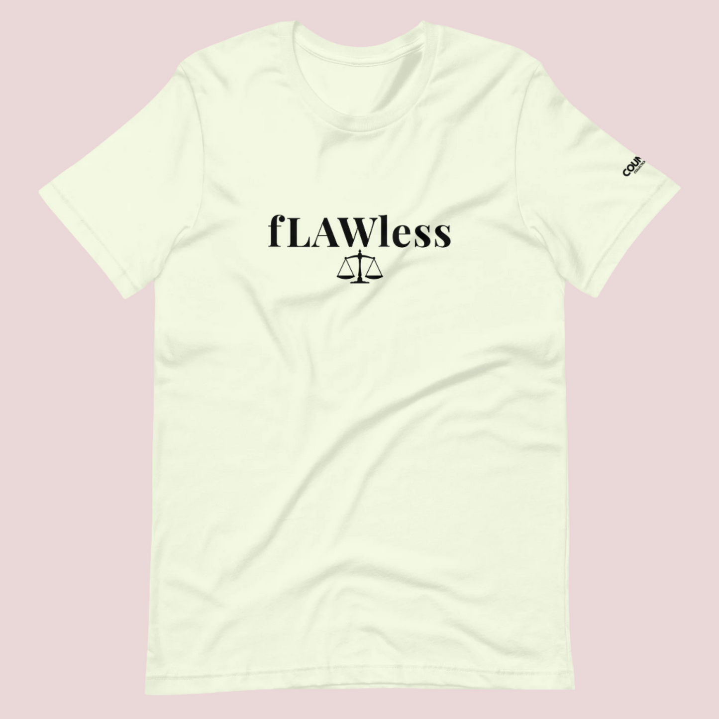A citron roundneck tee featuring the word "fLAWless", with the letters LAW in uppercase font, with an illustration of justice scales below. The counsellecollection logo is also seen on the left sleeve.™
