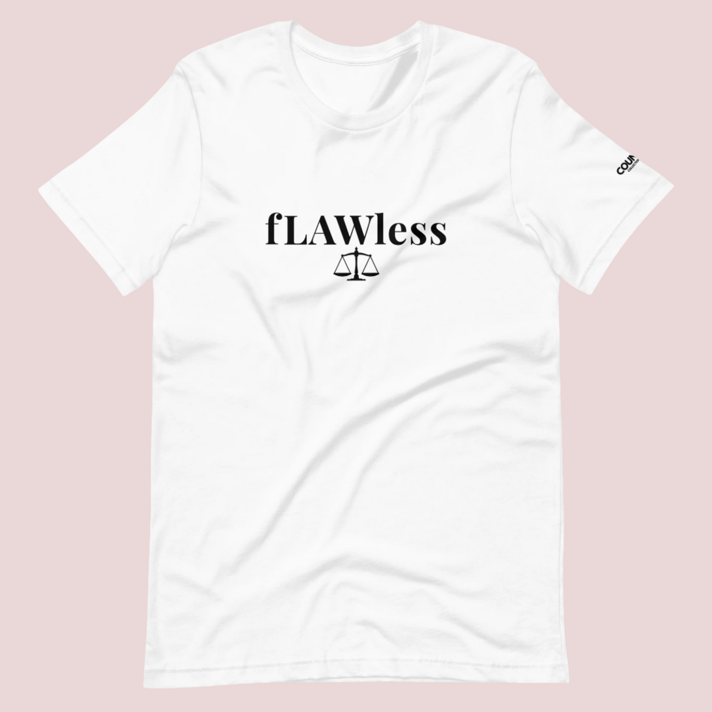 A white roundneck tee featuring the word "fLAWless", with the letters LAW in uppercase font, with an illustration of justice scales below. The counsellecollection logo is also seen on the left sleeve.