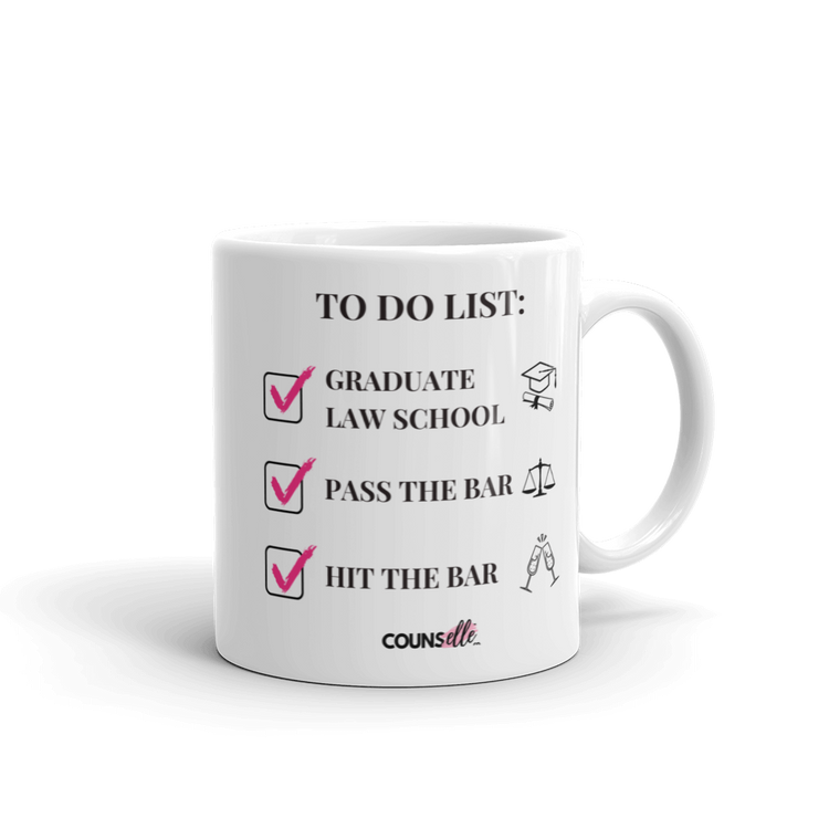 A white mug with a to-do list of graduate law schooll, pass the bar, hit the bar