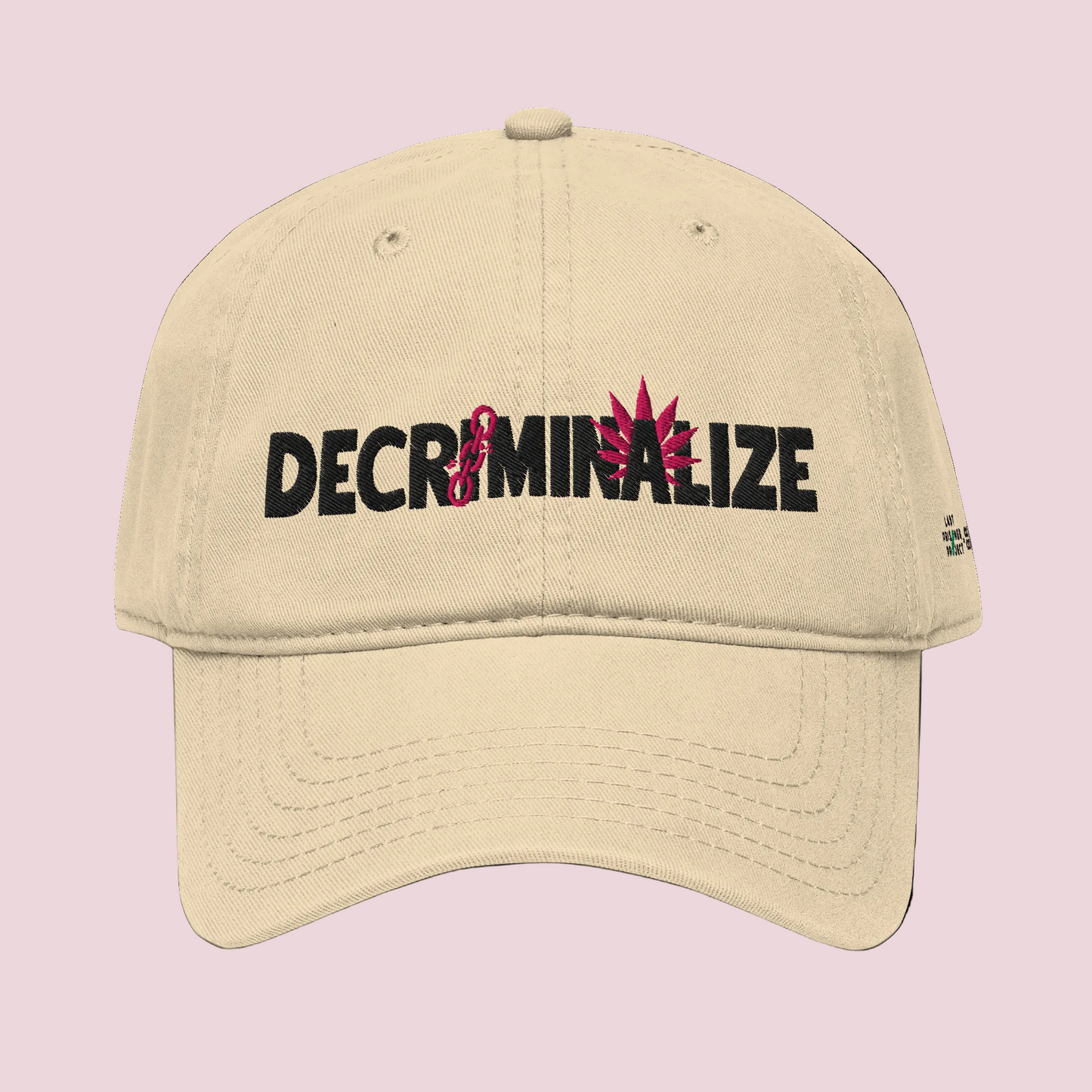 Beige cap with 'DECRIMINALIZE' text and cannabis leaf design on background