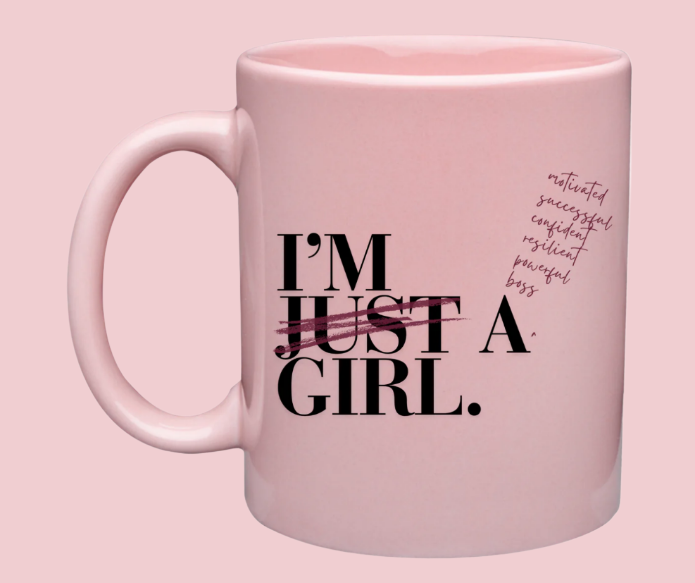 a picture of a pink ceramic mug with black letters that say "I'm just a girl"