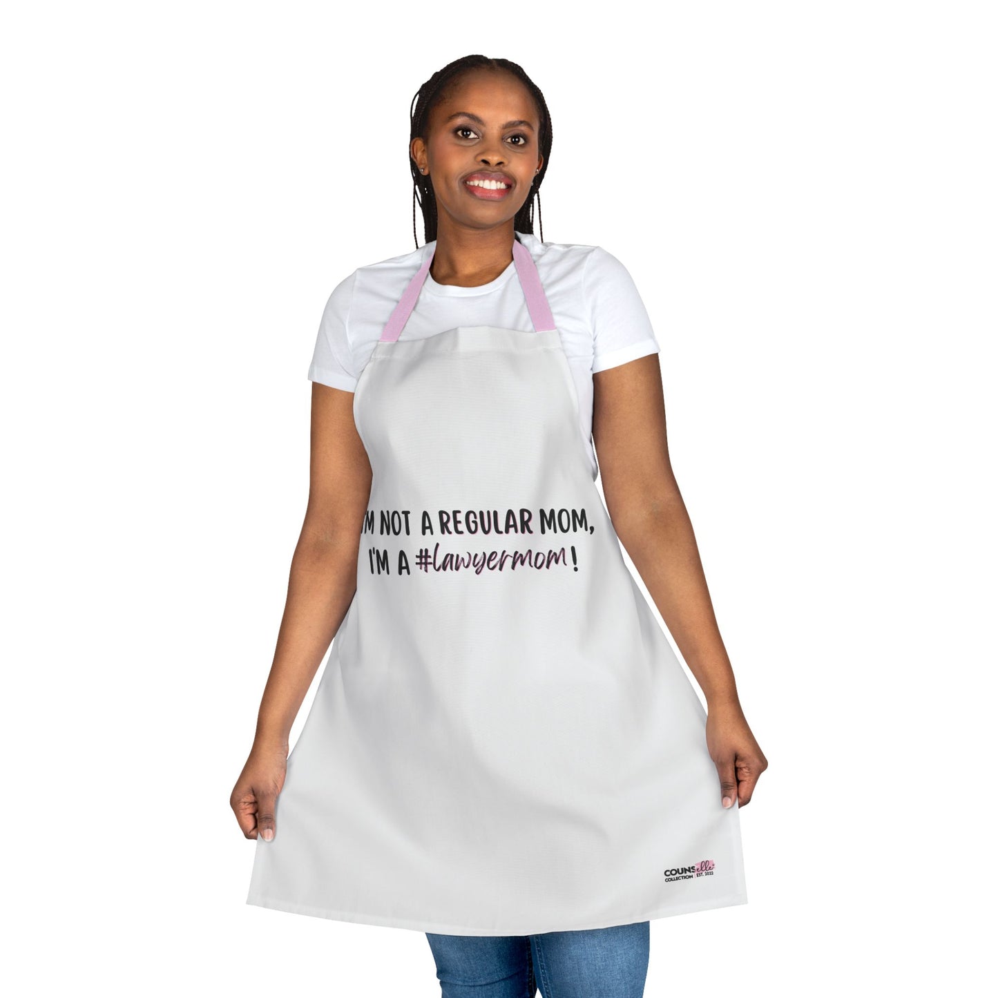 A white apron with the text "I'm not a regular mom, I'm a #lawyermom! - "The "Lawyer Mom" Apron by THE COUNSELLE COLLECTION™