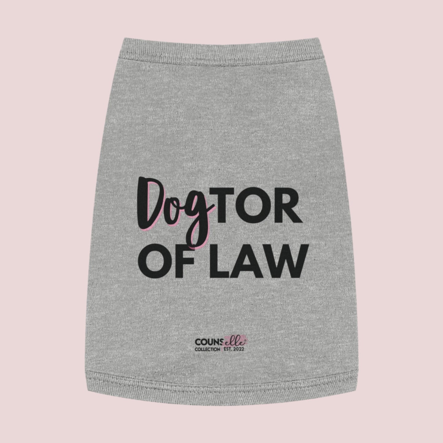 A grey pet tee  featuring the words "DogTOR OF LAW" and the counsellecollection logo near the hemline.