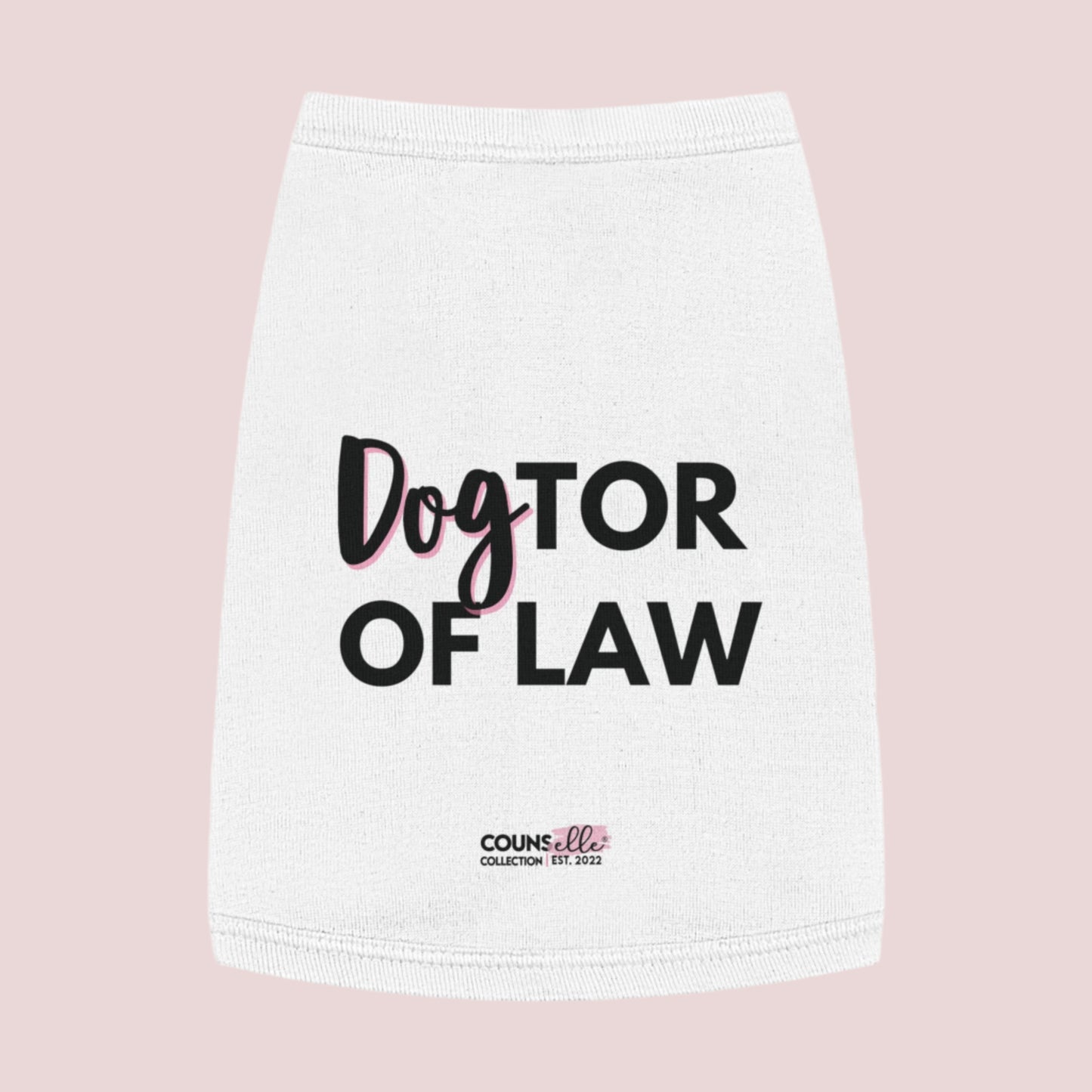 A white pet tee  featuring the words "DogTOR OF LAW" and the counsellecollection logo near the hemline.