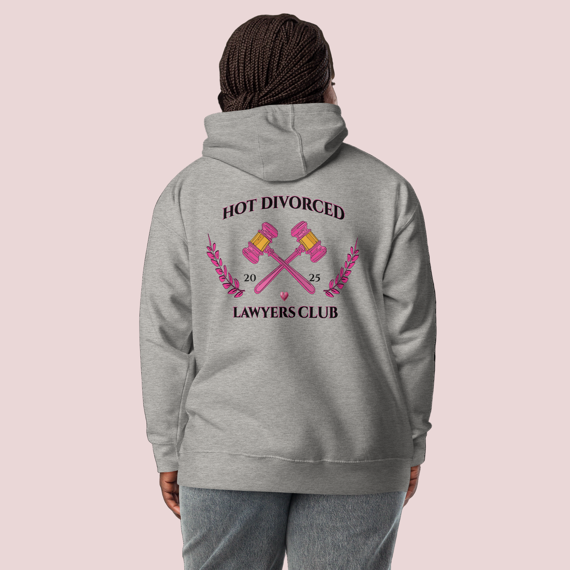 A black female model wearing a grey, long-sleeved hoodie featuring the words "HOT DIVORCED LAWYERS CLUB 2025" with crossed gavels, laurel leaves, and a broken heart graphics.