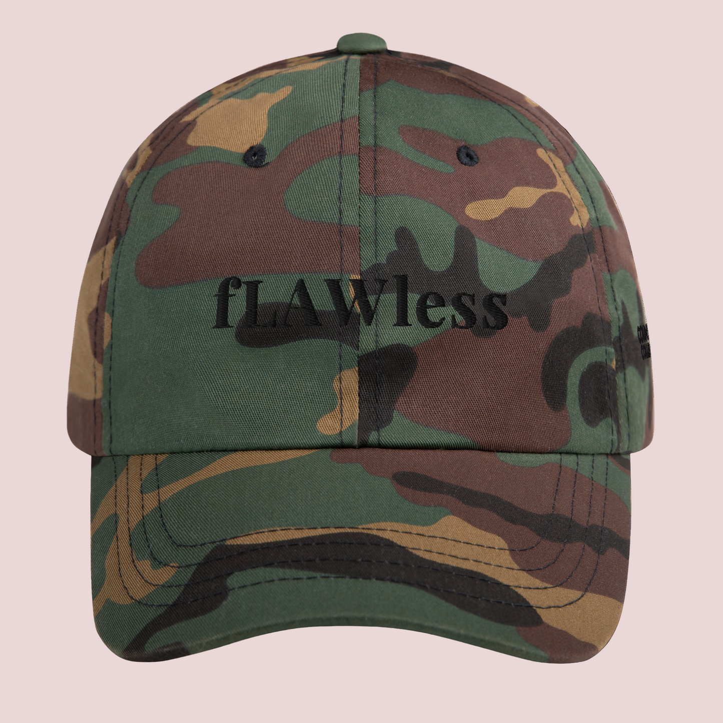 A camouflage cap featuring the word "fLAWless" in black font