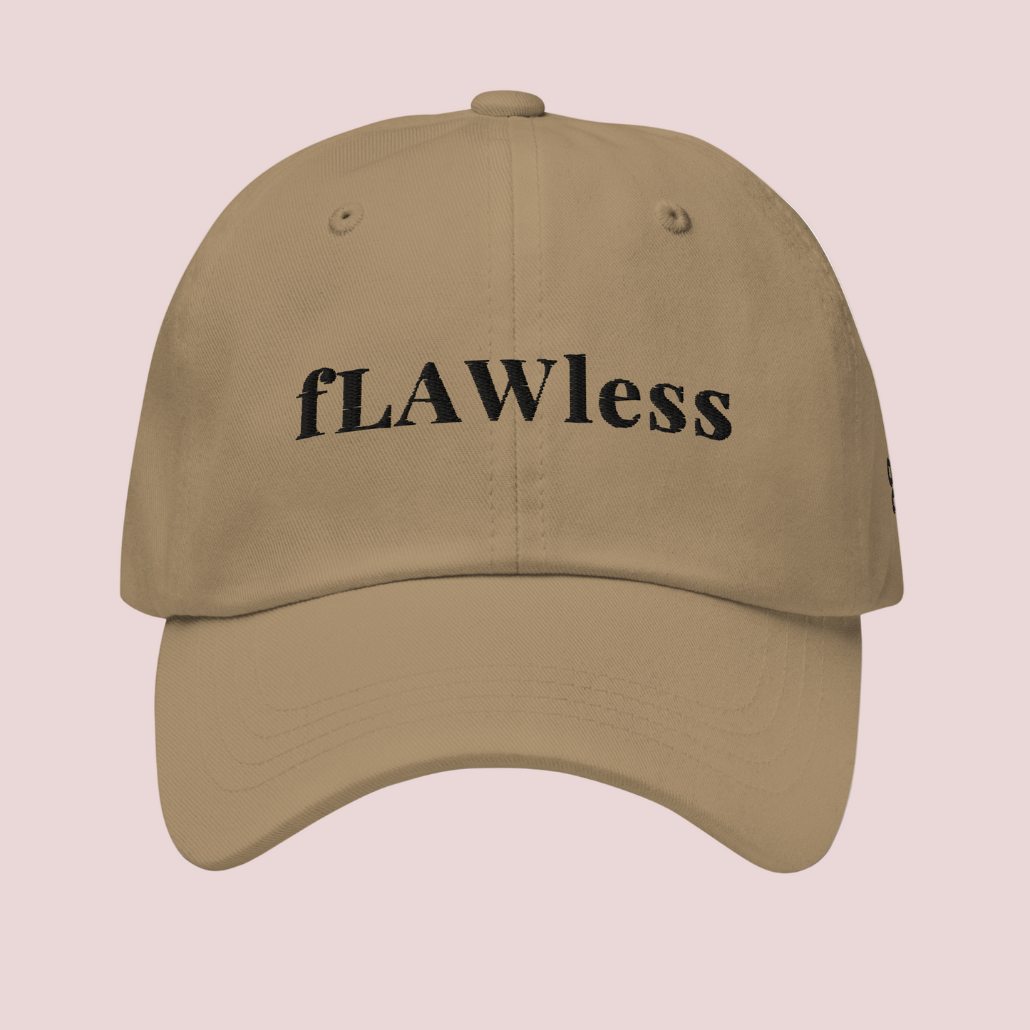 A khaki cap featuring the word "fLAWless" in black font