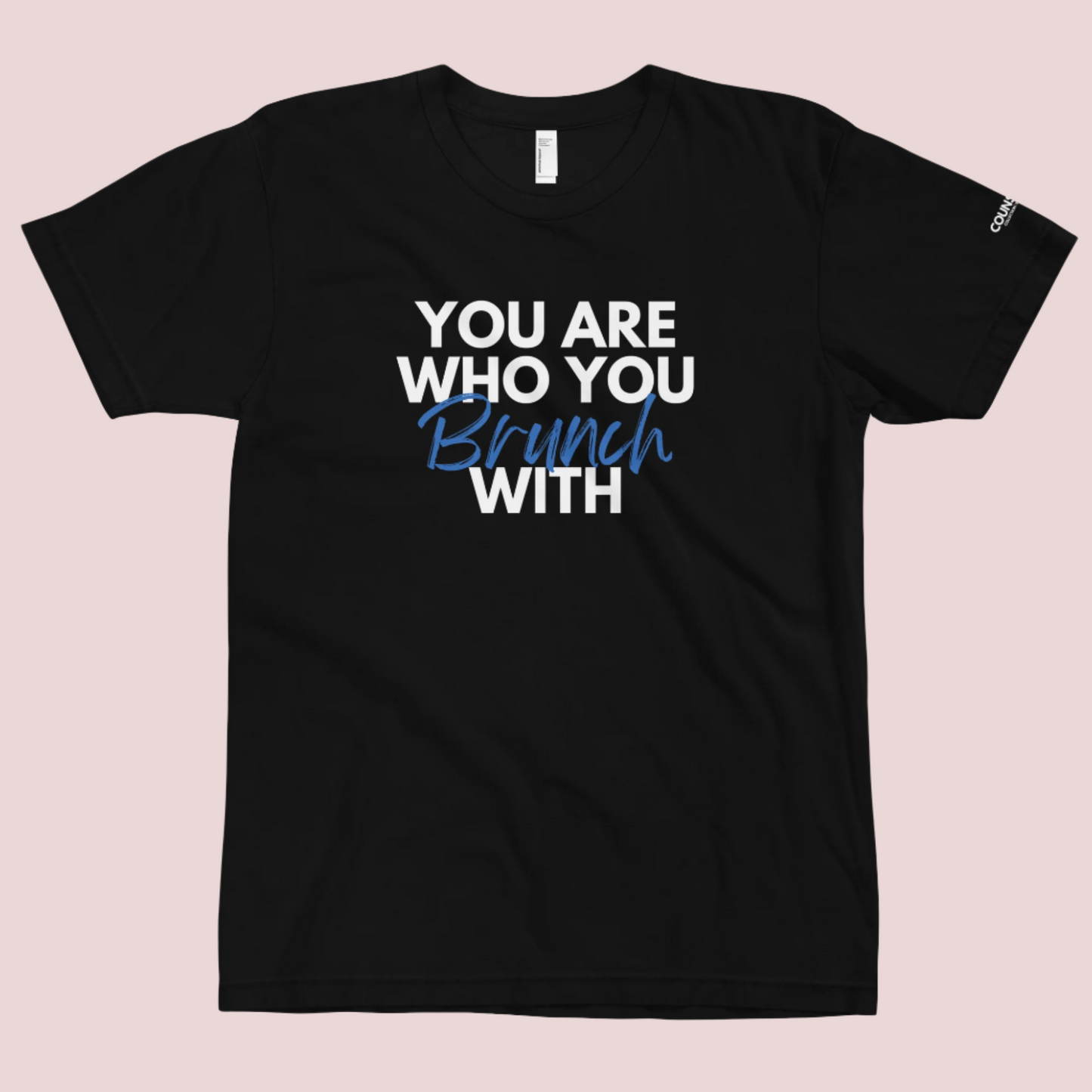 A black round neck short sleeved shirt featuring the slogan "You are who you brunch with" in front and the counsellecollection logo on the left sleeve.