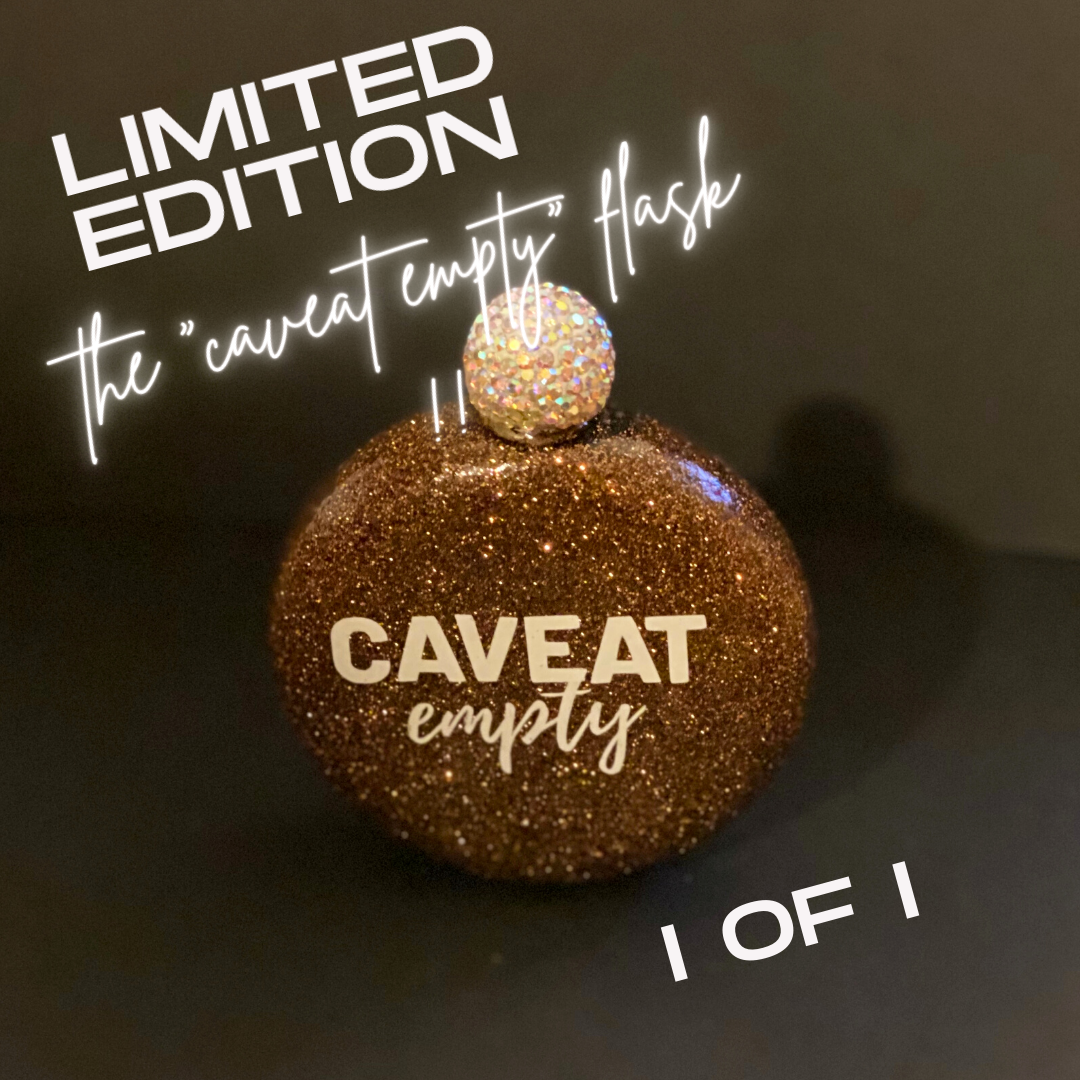 A glittery circular flask with a round bejeweled stopper, featuring the text "CAVEAT" in nlock uppercase letters and "empty" in script font.