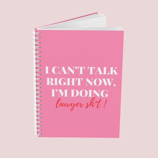 A pink notebook with the phrase "I can’t talk right now, I’m doing Lawyer sh*t" on the cover. Ring-bound with ruled pages.
