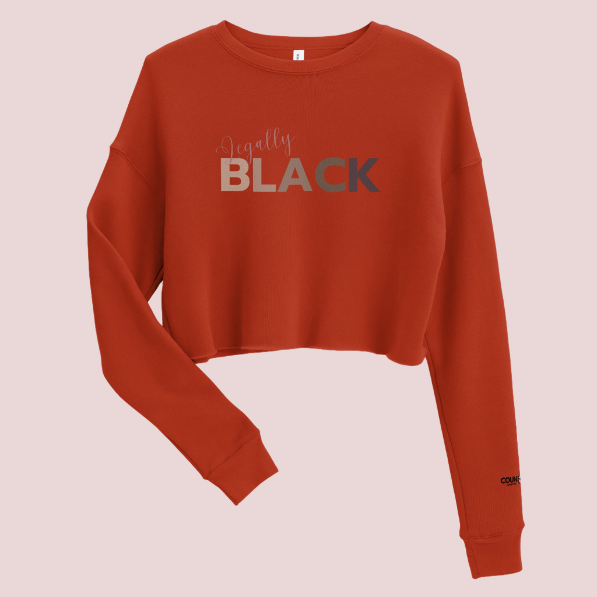 A brick red, roundneck, long-sleeved tee, with the text "Legally", in script, and "BLACK" in uppercase font. The counsellecollection logo is seen on the left sleeve.